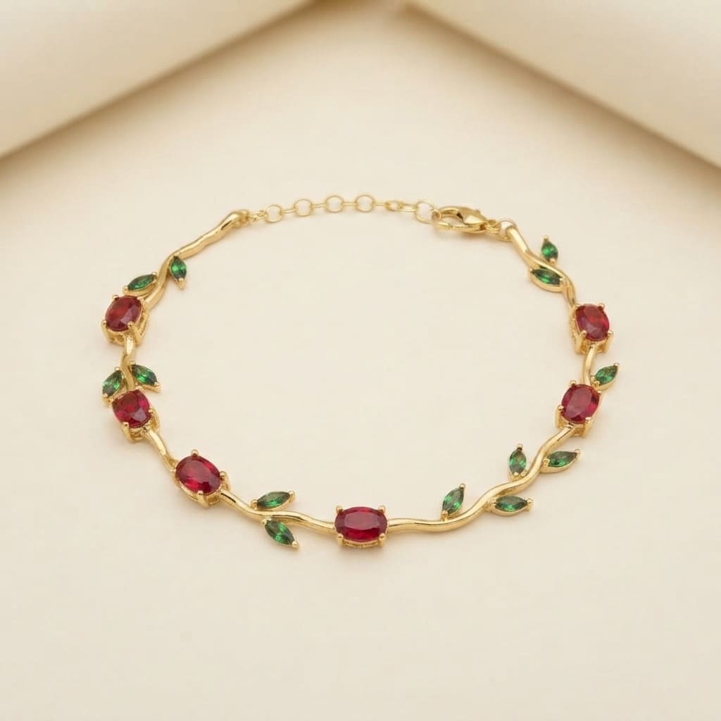 Gold vine-style tulip leaf bracelet with oval red crystals and green leaf accents on light beige background - Snap Mart Pakistan