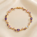 Gold vine-style tulip leaf bracelet with oval and marquise crystals in purple, light pink, and white on beige fabric - Snap Mart Pakistan