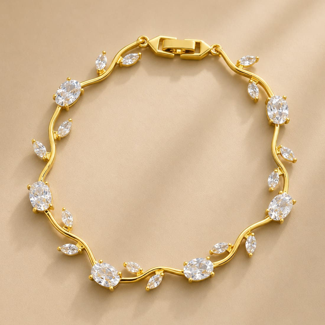 Gold vine-style tulip leaf bracelet with oval and marquise white crystals on soft beige background - Snap Mart Pakistan