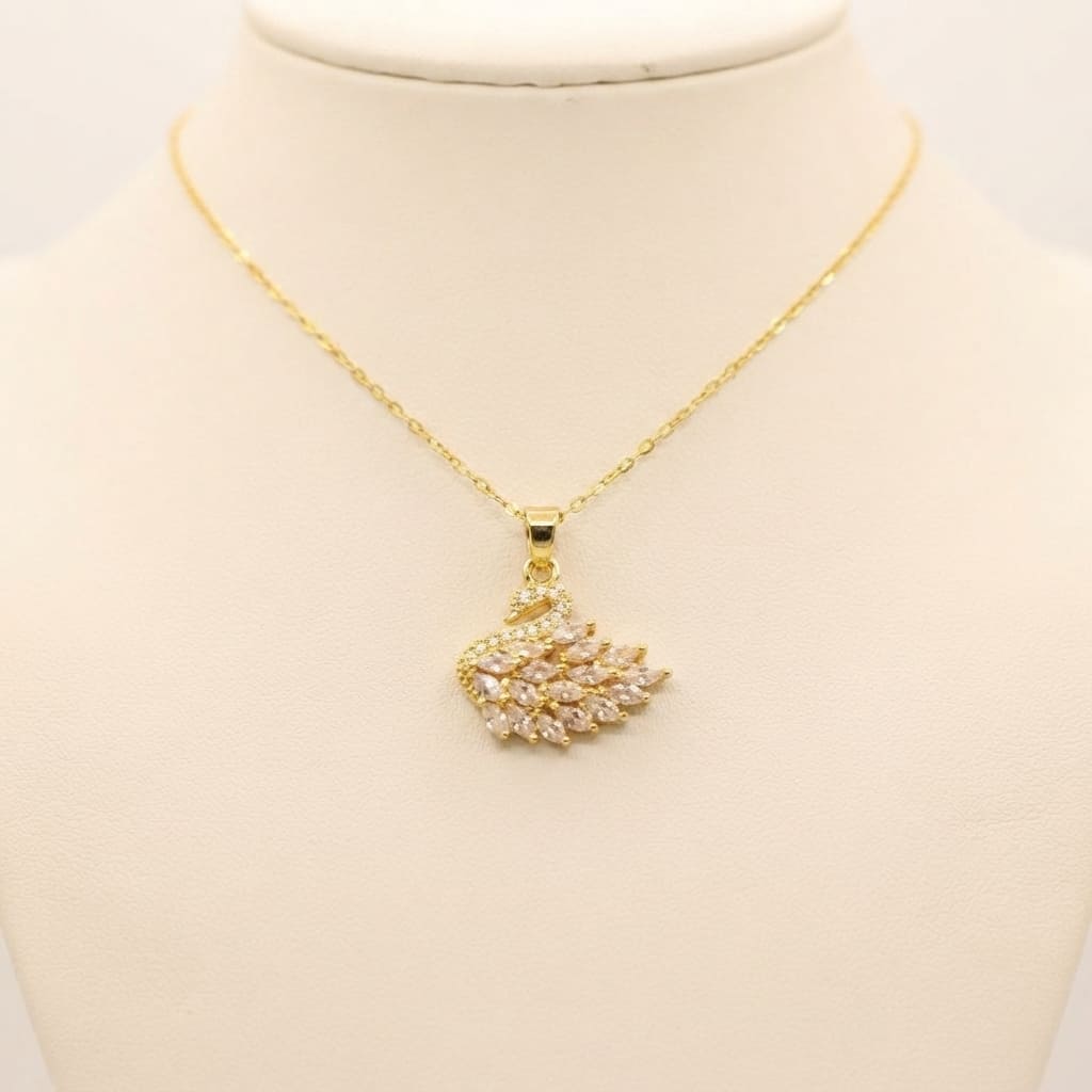 Gold crystal swan pendant necklace with sparkling stones on cream jewelry bust - Snap Mart Jewelry Pakistan