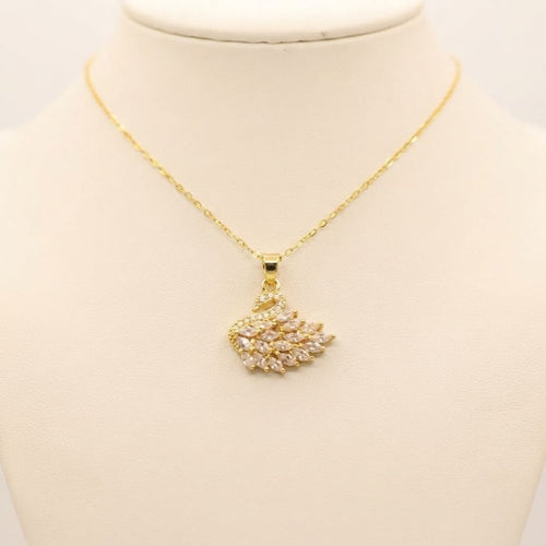 Gold crystal swan pendant necklace with sparkling stones on cream jewelry bust - Snap Mart Jewelry Pakistan