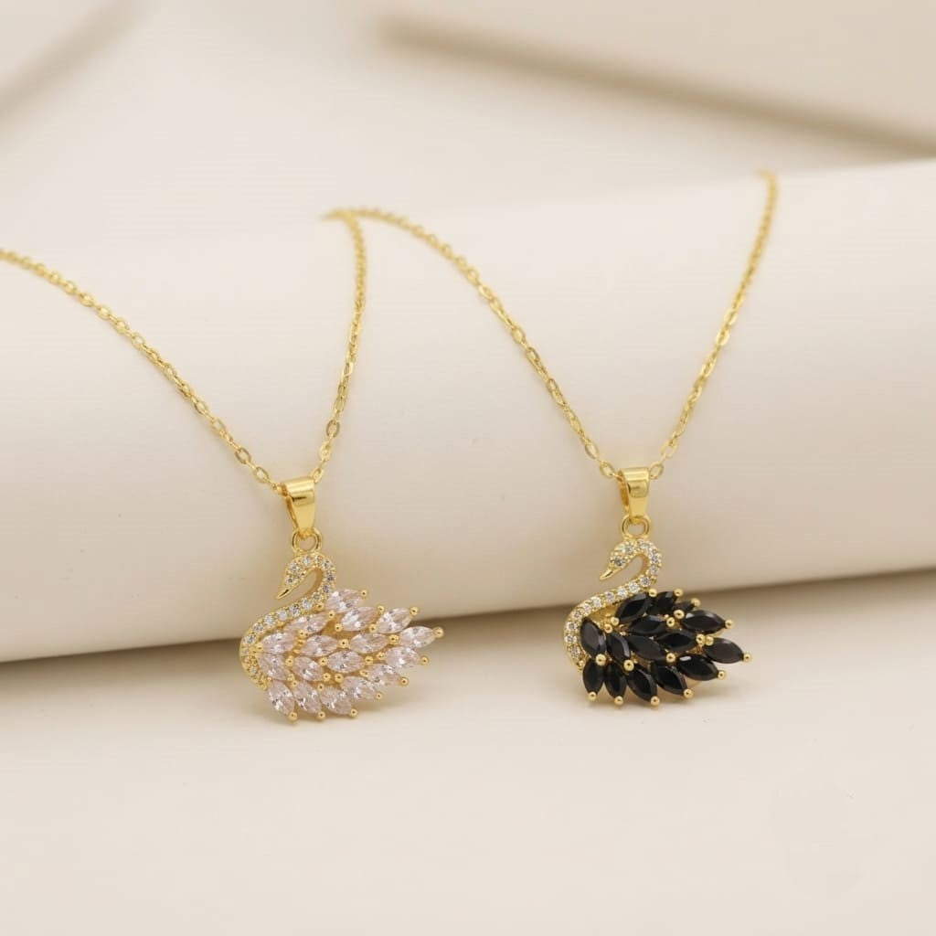 Gold crystal swan pendant necklaces with clear and black stones on white display stand - Snap Mart Jewelry Pakistan