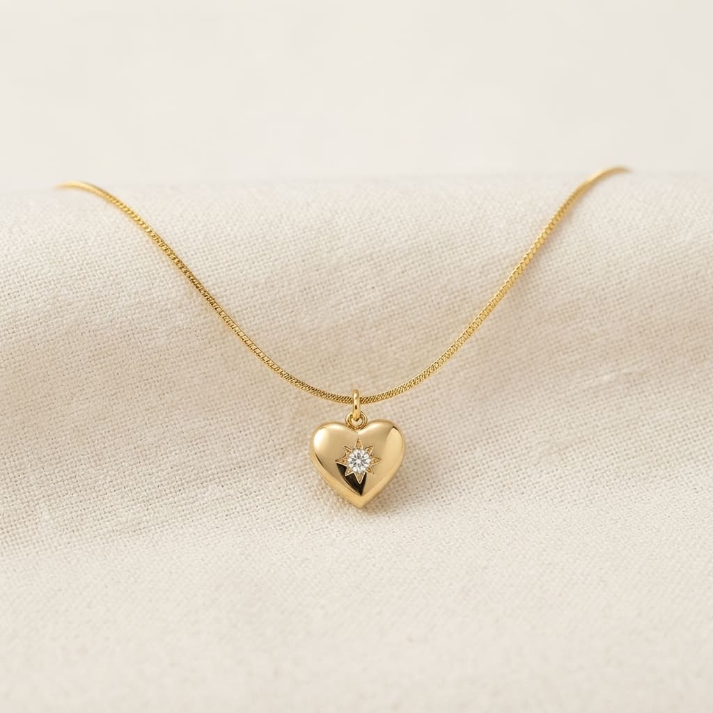 Golden heart pendant necklace with starburst stone on cream background - Snap Mart Jewelry Pakistan