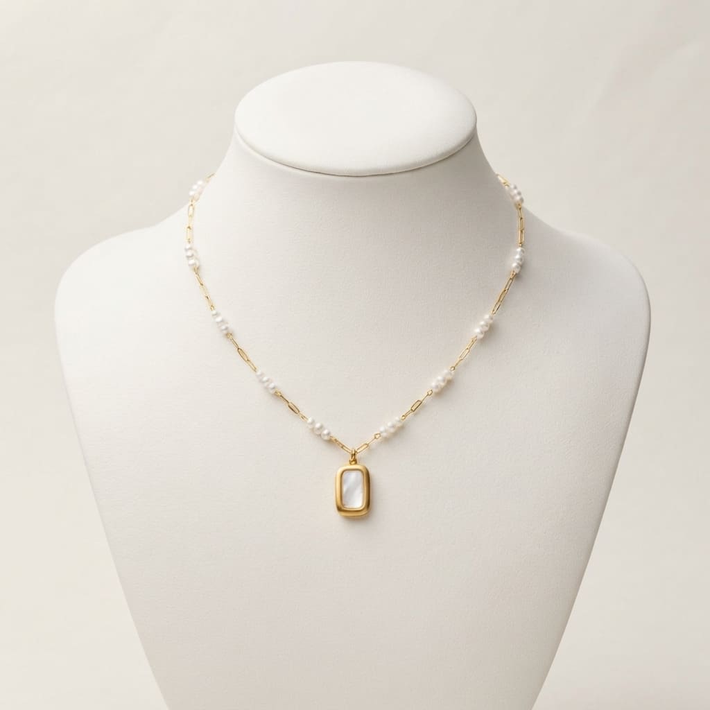 Golden rectangular pearl pendant necklace with mother of pearl inlay on white display bust - Snap Mart Jewelry Pakistan