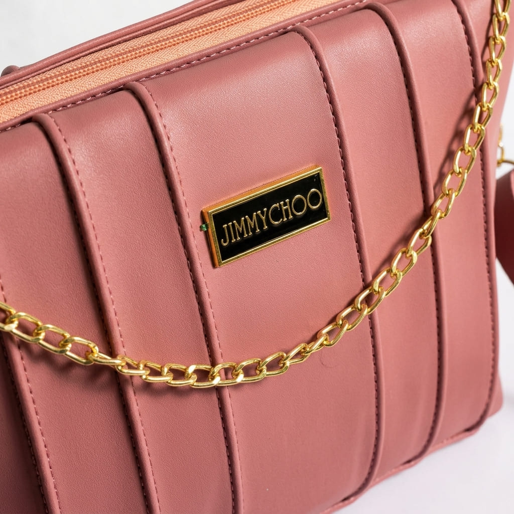 Close-up shot of Dusty rose pleated shoulder bag with gold chain accent