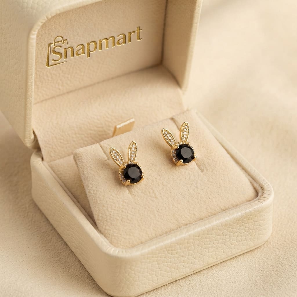 A pair of gold bunny stud earrings with black oval center stones presented in a Snap Mart jewelry box - Women Jewelry Pakistan