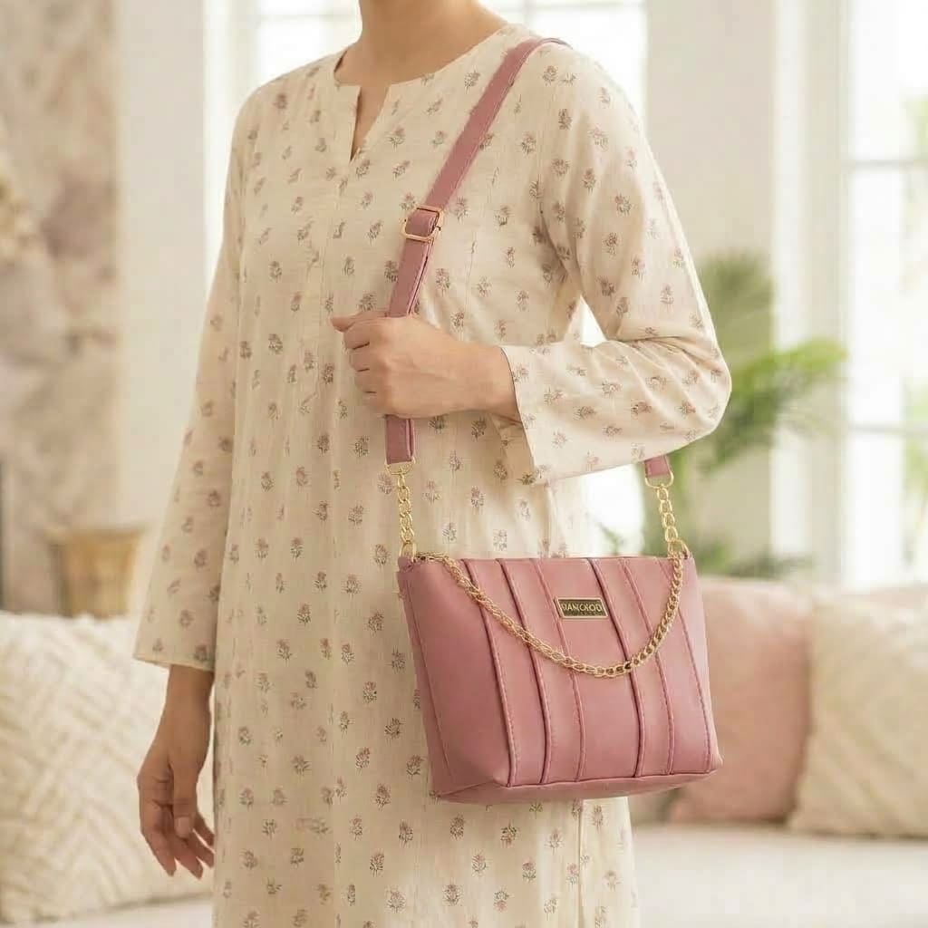 Woman wearing dusty rose pleated crossbody bag over printed floral dress - in pakistan